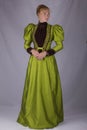 Late Victorian woman in green silk ensemble