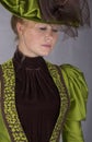 Late Victorian woman in green silk ensemble