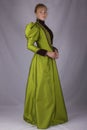 Late Victorian woman in green silk ensemble