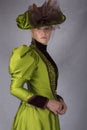 Late Victorian woman in green silk ensemble