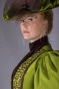 Late Victorian woman in green silk ensemble