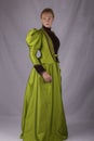 Late Victorian woman in green silk ensemble