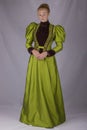 Late Victorian woman in green silk ensemble