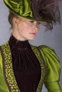 Late Victorian woman in green silk ensemble