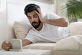 Late For Work. Shocked Overslept Indian Guy Looking At Alarm Clock Royalty Free Stock Photo