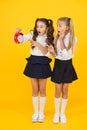 Latecomer will be punished. It is time. School schedule. School time. Schoolgirls and alarm clock. Children school Royalty Free Stock Photo