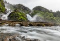 Latefoss twin waterfalls streams under the stone bridge archs, Odda, Hordaland county, Norway Royalty Free Stock Photo