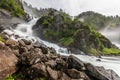 Latefoss waterfalls streams with stones in the foreground, Odda, Hordaland county, Norway Royalty Free Stock Photo