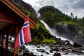 Latefossen Latefoss - one of the biggest waterfalls in Norway, with national flag on closeby building