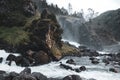 Latefossen unique waterfall side rock lightened in dark