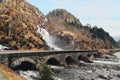 Latefossen Waterfall Odda Norway with the stone road bridge across in spring April season.