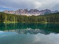 Latemar mount and woods reflected in Karersee lake, Dolomites, Italy