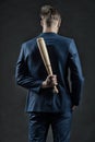 Latent aggression. Man with bat hides his aggression slow down and keep calm, rear view. Businessman or man in formal