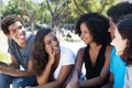 Later woman and african man talking with caucasian friends Royalty Free Stock Photo