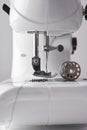 Lateral detail sewing machine needle and thread spool Royalty Free Stock Photo