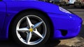 Lateral front side of shiny metallic blue fast car Royalty Free Stock Photo
