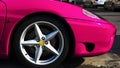 Lateral front side of shiny metallic pink sport car Royalty Free Stock Photo