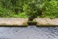 lateral metal door in a levada channel to divert irrigation water to another channel, Portuguese island of Madeira.