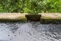 lateral metal door in a levada channel to divert irrigation water to another channel, Portuguese island of Madeira.