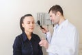 lateral view of a male otolaryngologist examining the ear