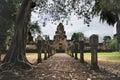 Laterite stone paved walkway with free-standing stone posts to the courtyard gates of ancient Khmer temple built of red sandstone