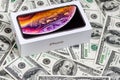 Latest Iphone XS in unopened box on US dollar banknotes background