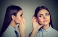 Latest rumors. Woman whispering in the ear to herself Royalty Free Stock Photo