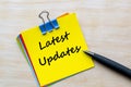 Latest updates text on yellow notepad. Business Updates concept Royalty Free Stock Photo