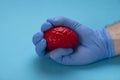 A latex glove hand squeezes a red brain. Brain treatment Royalty Free Stock Photo