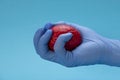 A latex glove hand squeezes a red brain. Brain treatment Royalty Free Stock Photo
