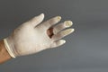 Latex glove hand tear, on gray background