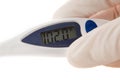 Latex Gloved Hand Holding An Thermometer