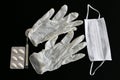 Latex gloves, thermometer, pills and medical mask on black background Royalty Free Stock Photo