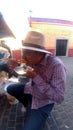 Latin adult man eats tostadas de cueritos in the colonial streets of latin america, delicious traditional street food and part of