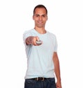 Latin adult man pointing with remote control Royalty Free Stock Photo