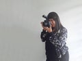 Latin adult woman takes pictures happy with professional camera as hobby and work of successful working woman