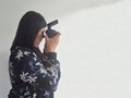 Latin adult woman takes pictures happy with professional camera as hobby and work of successful working woman