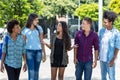 Latin american and african and hispanic young adults walking and talking in city Royalty Free Stock Photo