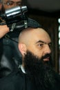 Latin American barber working the style with a long beard in the city of Bogot Royalty Free Stock Photo