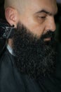Latin American barber working the style with a long beard in the city of Bogot Royalty Free Stock Photo