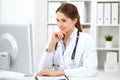 Latin american doctor woman standing with arms crossed and smiling at hospital. Physician ready to examine patient Royalty Free Stock Photo