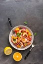 Latin American food. Ceviche salad with shrimps and oranges on a dark rustic background. Top view, flat lay, copy space Royalty Free Stock Photo