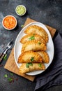 Latin American fried empanadas with tomato and avocado sauces. Top view Royalty Free Stock Photo