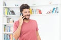 Latin american hipster man talking at mobile phone Royalty Free Stock Photo