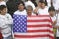 Latin American man holds US flag