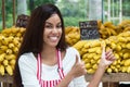 Latin american saleswoman at farmers market with bananas Royalty Free Stock Photo