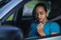 Latin woman putting on seat belt to drive vehicle Royalty Free Stock Photo