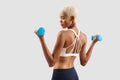 Latin American woman lifts dumbbells, young female athlete doing fitness workout, engaged in physical activity to improve health Royalty Free Stock Photo