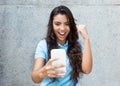 Latin american woman receiving good news on phone Royalty Free Stock Photo