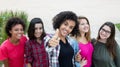 Latin american woman showing thumb with group of girlfriends Royalty Free Stock Photo